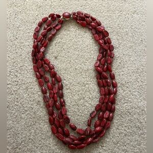 Red beaded triple necklace.